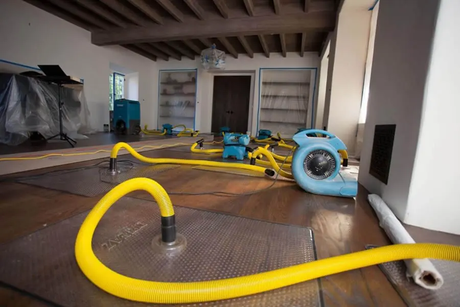Technician extracting standing water from a floor in a Marietta, GA home